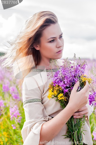 Image of Attractive sad girl on meadow