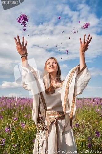 Image of Beautiful woman relaxing on meadow with flowers