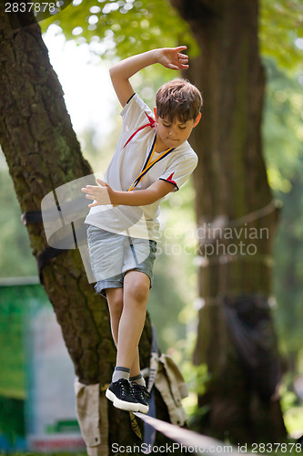 Image of Little boy balancing on a tightrope