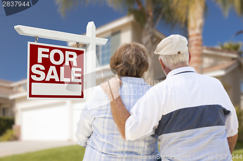 Image of Happy Senior Couple Front of For Sale Sign and House