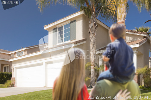 Image of Mixed Race Young Family Looking At Beautiful Home