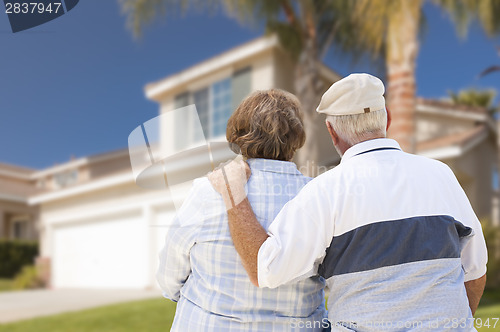 Image of Happy Senior Couple Looking at Front of House