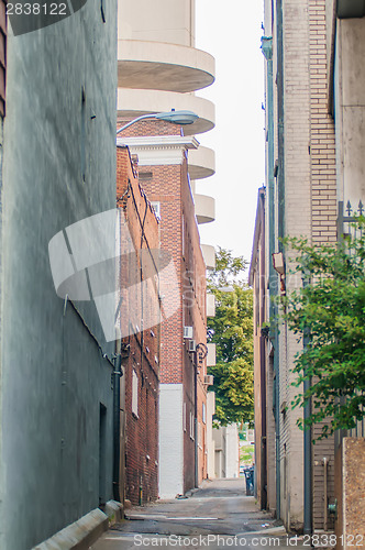 Image of orld brick building in abandoned neighborhood alley