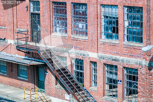 Image of orld brick building in abandoned neighborhood alley