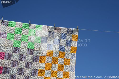 Image of Patchwork counterpane on a clothes-line