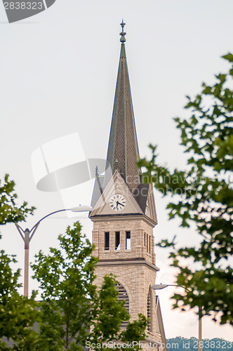 Image of church steeple seen in a city