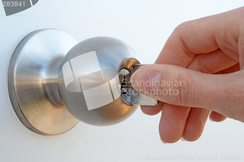 Image of Hand unlocking the door