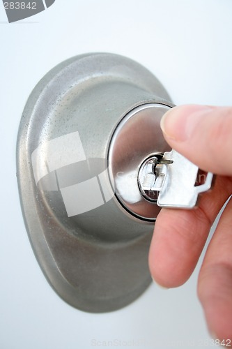 Image of Hand unlocking the door with a key