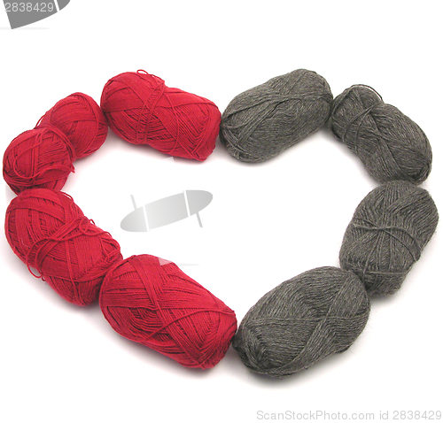 Image of Gray and red new wool as heart on white background
