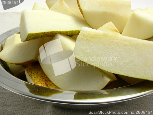 Image of Quatered pears in a metalplate on a placemat
