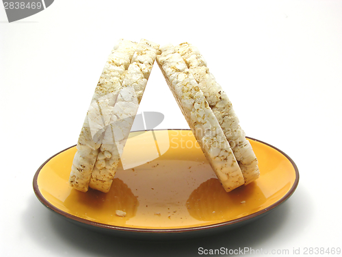 Image of Slices of puffed rice arranged on a bowl of ceramik on white