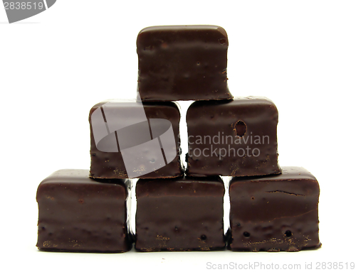 Image of A few dominos arranged as a pyramid on white background