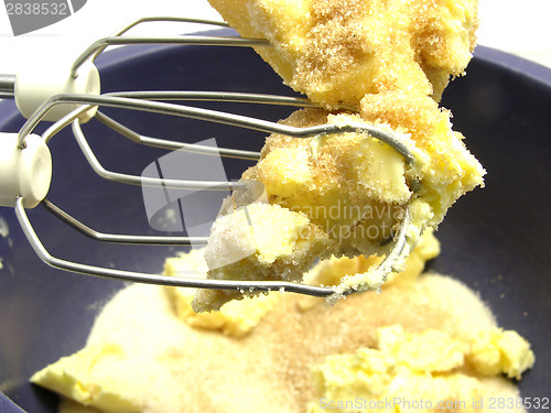 Image of Margarine and cane sugar mixed with stirring staffs in a blue bo