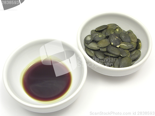 Image of Two bowls of chinaware with pumpkin seeds and pumpkin seed oil