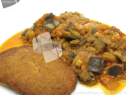 Image of Breaded bean curd cutlet with fried vegetable on a white plate