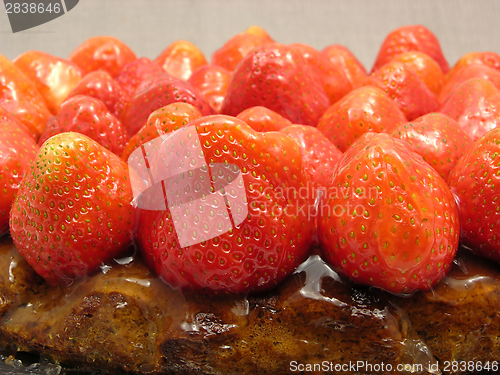 Image of Lateral close-up view of a strawberry cake on gray background