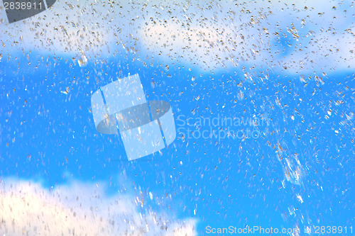 Image of Rain drops on blue sky background