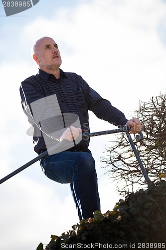 Image of Thoughtful man sitting on a flight of steps