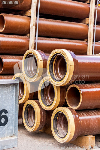 Image of Several pipes stacked in yard