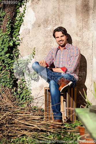 Image of Male model sitting with legs crossed