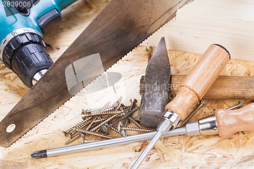 Image of Drill with timber, screwdrivers and screws