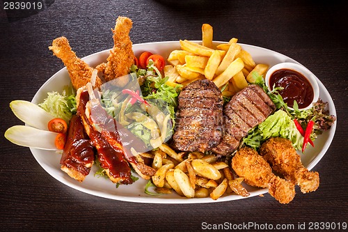 Image of Platter of mixed meats, salad and French fries