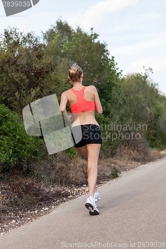 Image of Fit young woman jogging