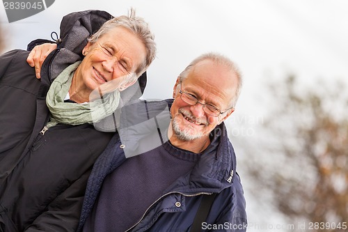 Image of happy mature couple relaxing baltic sea dunes 