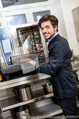 Image of Chef cooking a vegetables stir fry over a hob