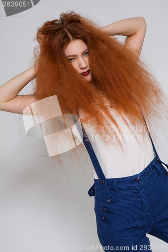 Image of Female model playing with frizzy hair