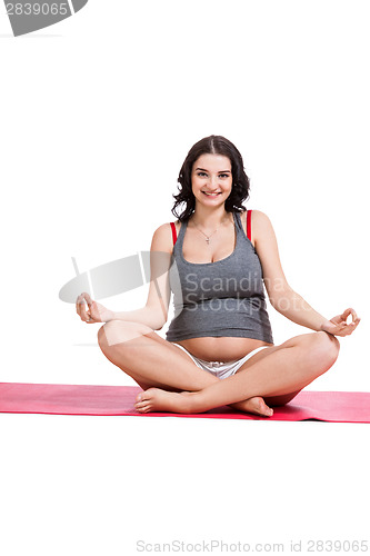 Image of Pregnant woman practising yoga and meditating