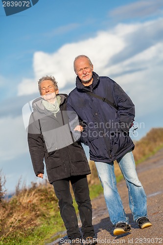 Image of happy mature couple relaxing baltic sea dunes 