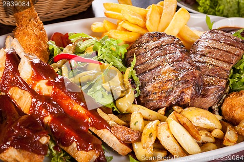 Image of Platter of mixed meats, salad and French fries