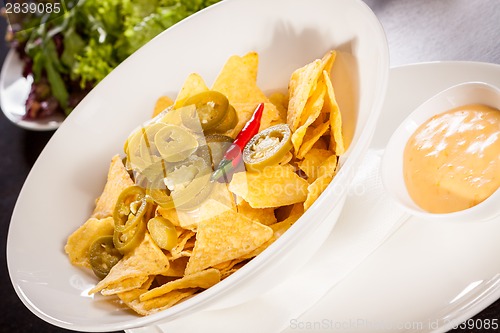 Image of Nachos with cheese sauce and chilli pepperoni