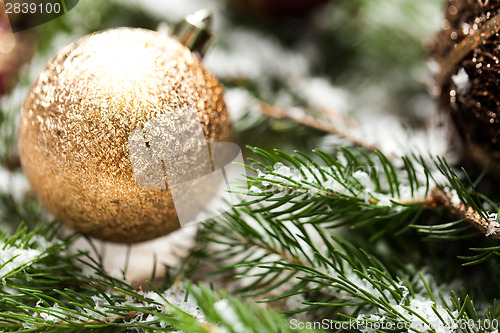 Image of Gold Christmas ornament on leaves