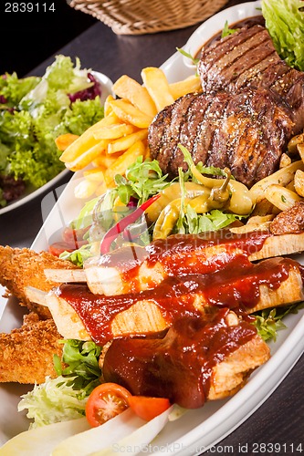 Image of Platter of mixed meats, salad and French fries