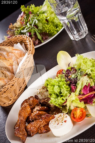 Image of grilled beef stripes fresh salad and goat cheese