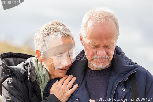 Image of happy elderly senior couple walking on beach