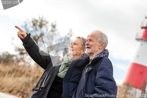 Image of happy mature couple relaxing baltic sea dunes 