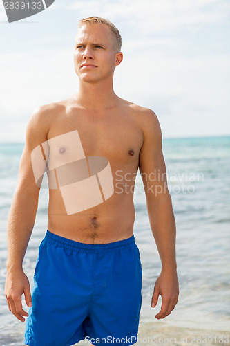 Image of Man in blue swim shorts in the beach
