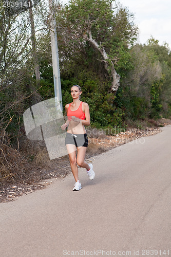 Image of Fit young woman jogging