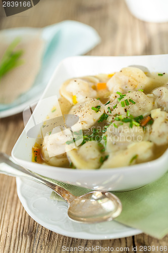 Image of Dish of savory pork tortellini in broth pelmeni russian