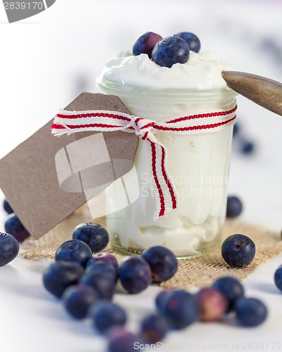 Image of Jar of clotted cream or yogurt with blueberries