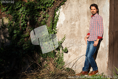 Image of Male model leaning against wall