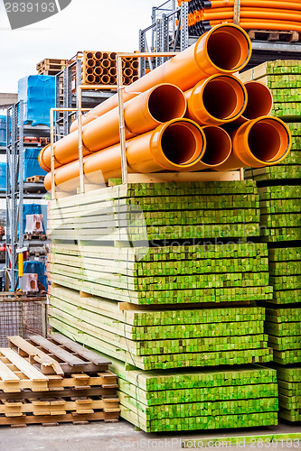 Image of Several pipes stacked in yard