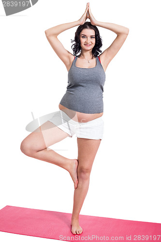 Image of Active young pregnant woman doing yoga