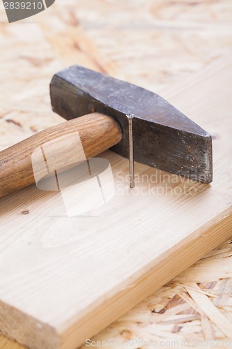 Image of Mallet with nails and planks of new wood