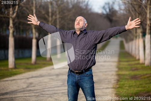 Image of Middle-aged man enjoying the sunshine