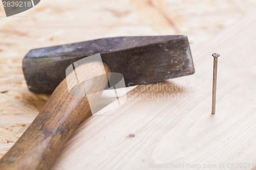 Image of Mallet with nails and planks of new wood