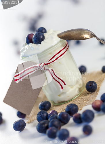 Image of Jar of clotted cream or yogurt with blueberries